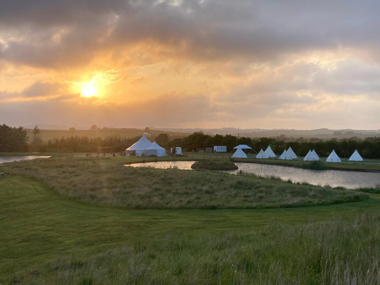 Wedding marquee in evening sunset at Chatton Lakes