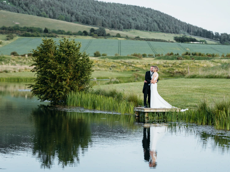Wedding couple overlooking lake