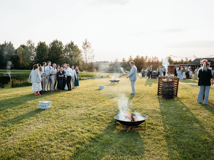 Wedding guests outside marquee at Chatton Lakes